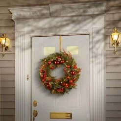 National Tree Company Pre-Lit Artificial Christmas Wreath, Green, Evergreen, White Lights, Decorated With Ball Ornaments, Red Sprigs, Christmas Collection, 24 Inches